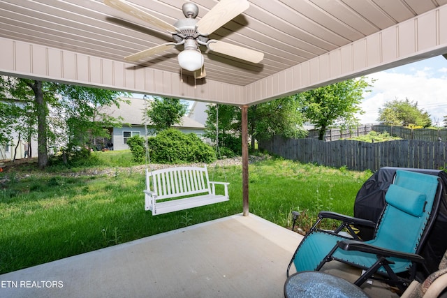 view of patio featuring ceiling fan and fence