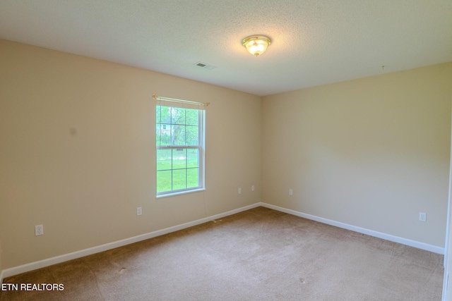 spare room featuring visible vents, baseboards, and carpet floors