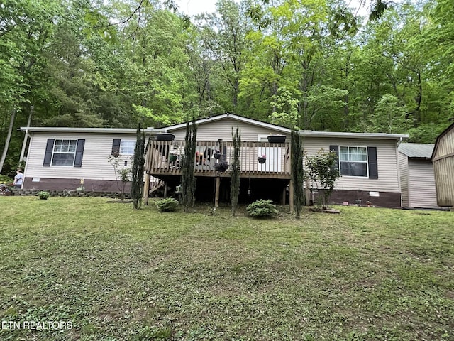 back of house featuring a wooden deck, a yard, and crawl space