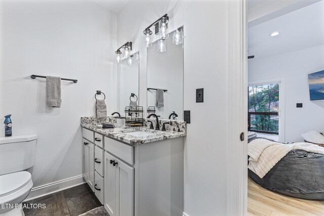 790 Pleasure Rd, Sevierville, TN 37876 - full bathroom featuring a sink, double vanity, toilet, baseboards, and ensuite bath