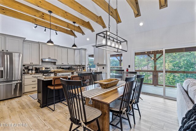 790 Pleasure Rd, Sevierville, TN 37876 - dining space featuring light wood-style flooring, beam ceiling, and high vaulted ceiling