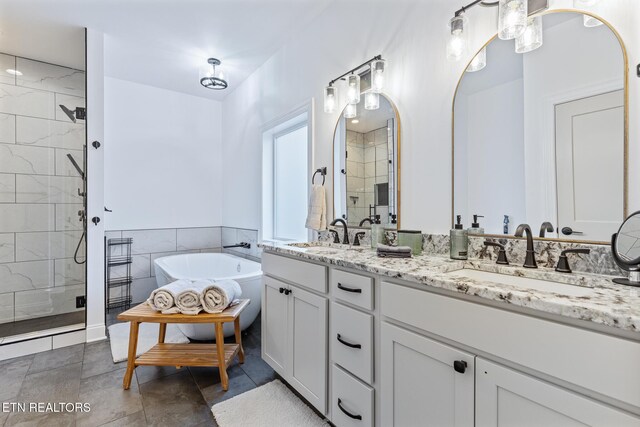 790 Pleasure Rd, Sevierville, TN 37876 - bathroom with double vanity, a sink, a freestanding bath, and a stall shower