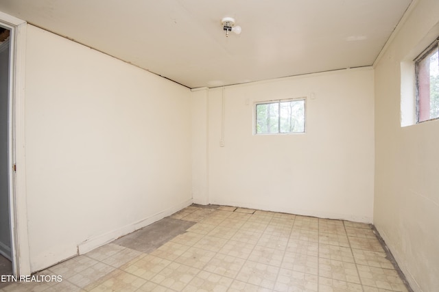 empty room with a healthy amount of sunlight and light floors