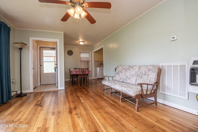 sitting room with visible vents, ornamental molding, light wood-style flooring, and ceiling fan