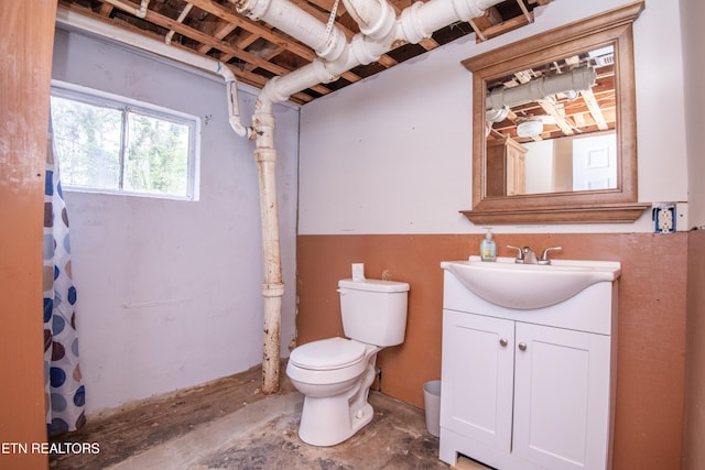 bathroom featuring vanity, concrete floors, toilet, and a shower with curtain