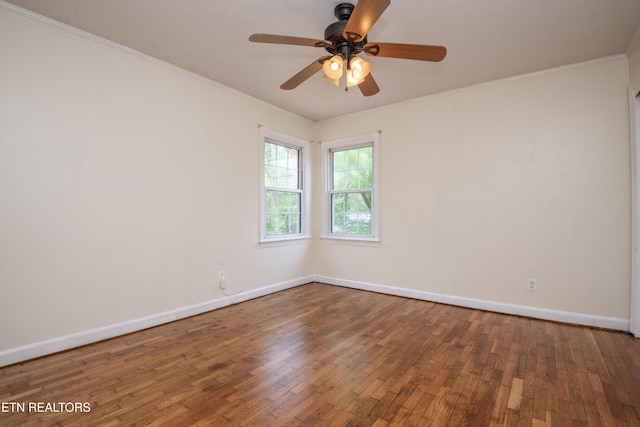 spare room featuring baseboards, ornamental molding, ceiling fan, and hardwood / wood-style floors