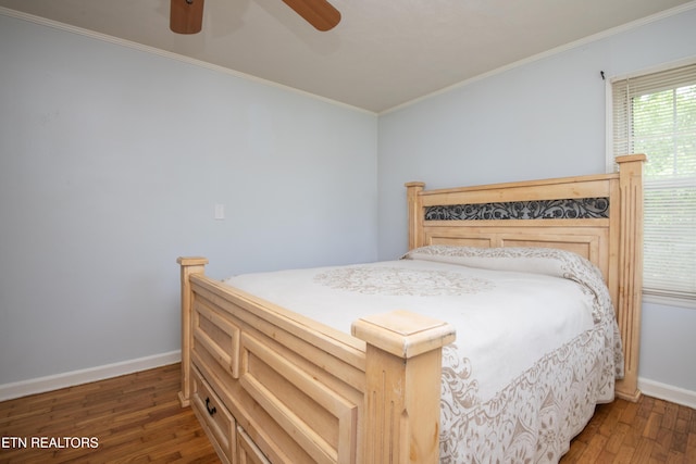 bedroom with crown molding, a ceiling fan, baseboards, and wood finished floors