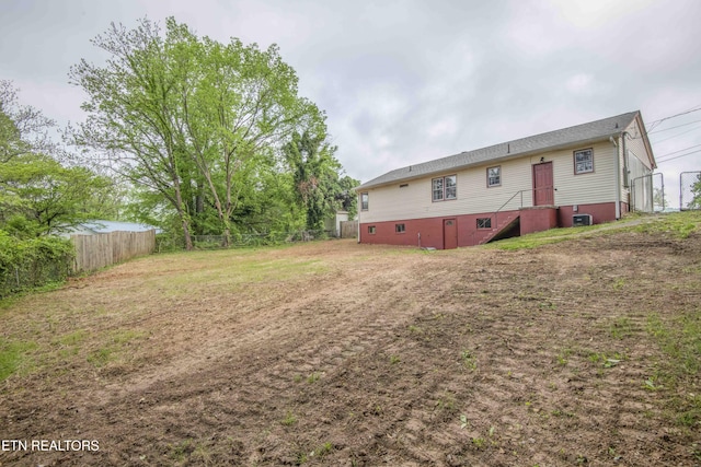 back of property featuring fence
