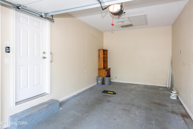 garage with baseboards and a garage door opener