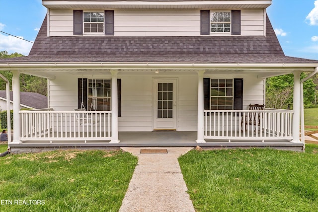 1921 Spring Hill Rd, Knoxville, TN 37914 - view of front of home featuring a porch, roof with shingles, and a front lawn