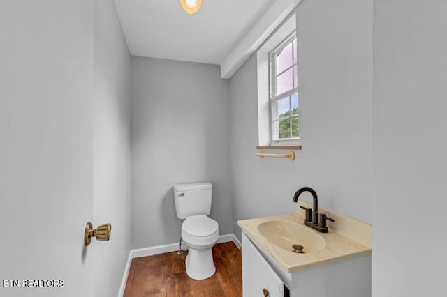 1921 Spring Hill Rd, Knoxville, TN 37914 - half bathroom featuring baseboards, toilet, wood finished floors, and vanity