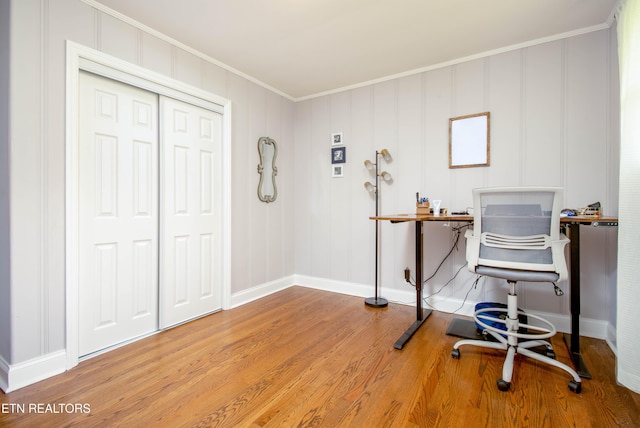 office space with baseboards, ornamental molding, and wood finished floors