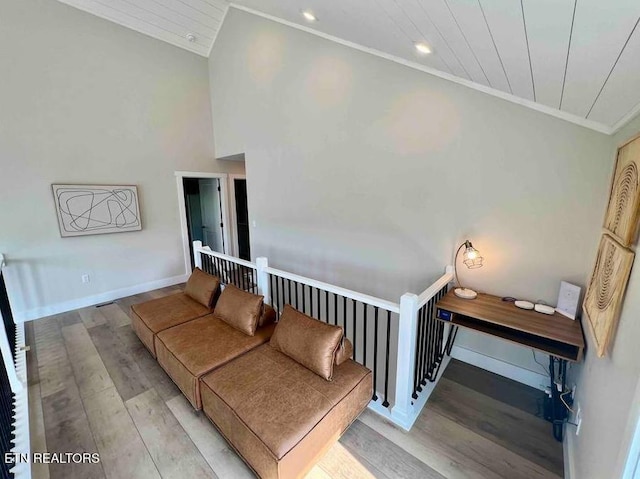 stairs featuring baseboards, wood finished floors, recessed lighting, and ornamental molding