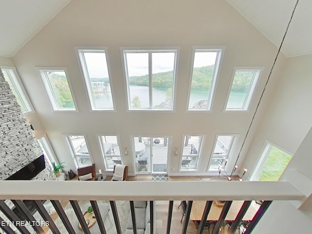 interior space with high vaulted ceiling and a water view