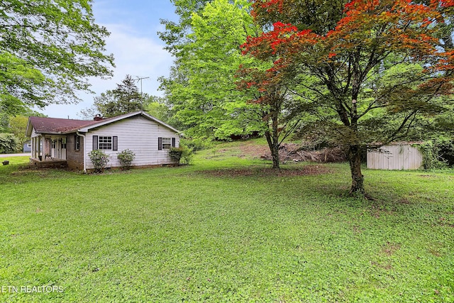 view of yard featuring an outbuilding and a storage unit