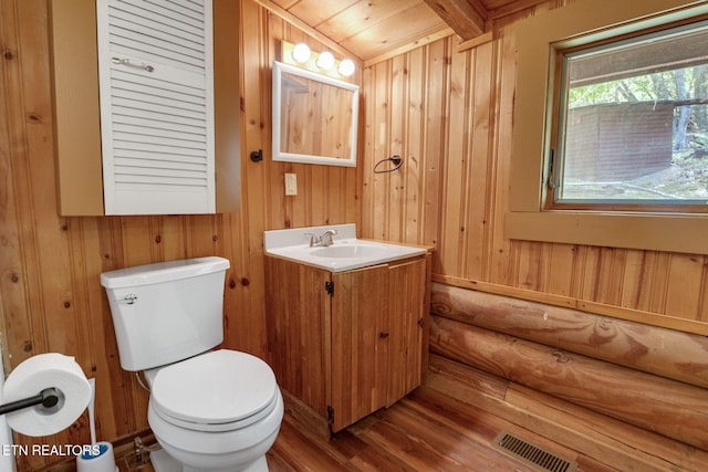 4360 Lakeshore Ave, Sevierville, TN 37876 - bathroom featuring wooden walls, vanity, toilet, wood finished floors, and visible vents