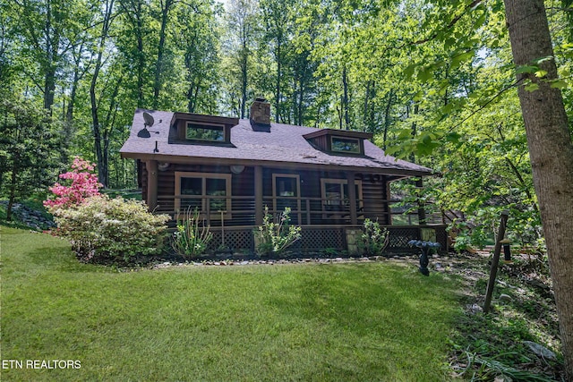 4360 Lakeshore Ave, Sevierville, TN 37876 - view of front facade with covered porch, log exterior, a front yard, and a chimney