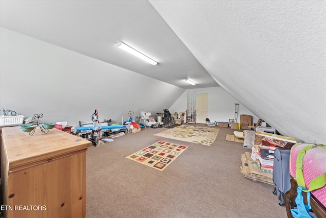 rec room with vaulted ceiling and carpet floors