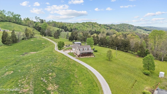 drone / aerial view featuring a rural view and a forest view