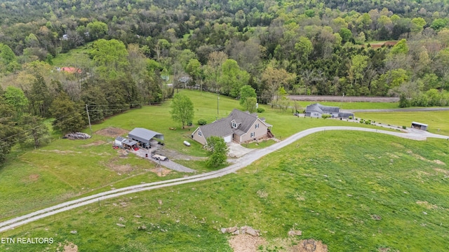 drone / aerial view featuring a forest view