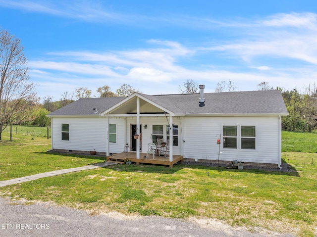 ranch-style house with a wooden deck, roof with shingles, crawl space, and a front lawn