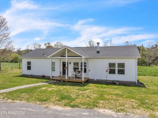ranch-style house featuring crawl space, a wooden deck, roof with shingles, and a front yard