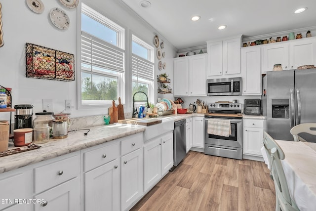 kitchen featuring recessed lighting, white cabinetry, and stainless steel appliances
