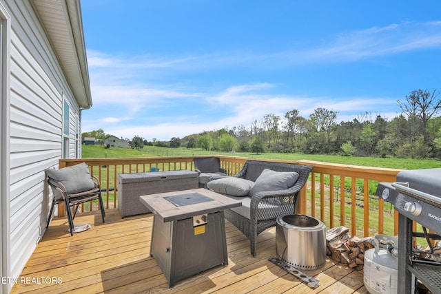 wooden terrace featuring an outdoor living space with a fire pit and area for grilling