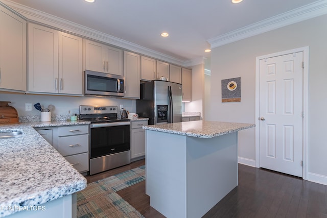 kitchen with gray cabinets, stainless steel appliances, ornamental molding, and recessed lighting
