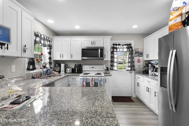 kitchen featuring a sink, white cabinetry, and stainless steel appliances