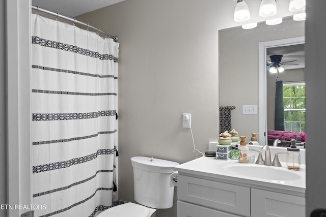 bathroom with a shower with shower curtain, ceiling fan, toilet, and vanity