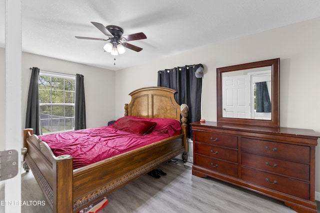 bedroom with a ceiling fan and light wood-style flooring