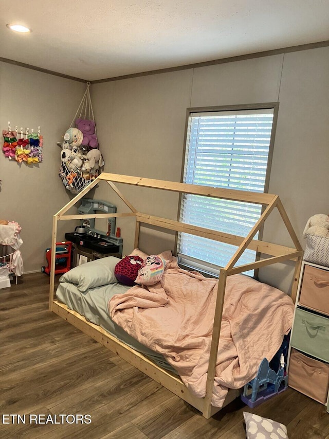 bedroom featuring wood finished floors and recessed lighting