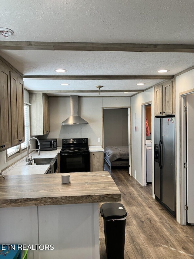kitchen with wall chimney range hood, black range with electric stovetop, a textured ceiling, stainless steel refrigerator with ice dispenser, and dark wood-style flooring