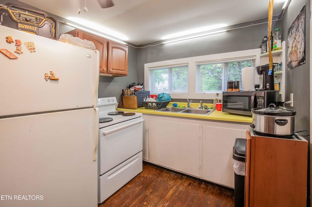 kitchen with dark wood finished floors, light countertops, a ceiling fan, a sink, and white appliances