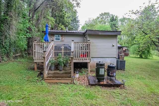 back of house with a yard and a deck