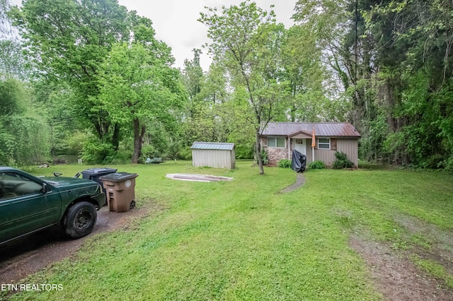 view of yard with a storage unit and an outbuilding