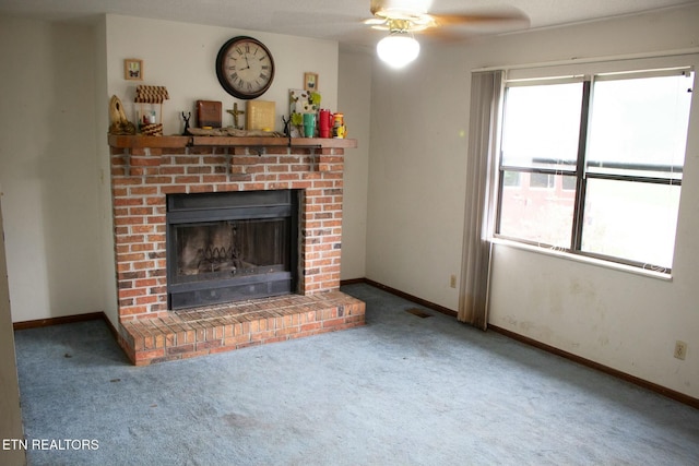living area featuring ceiling fan, visible vents, carpet floors, baseboards, and a brick fireplace