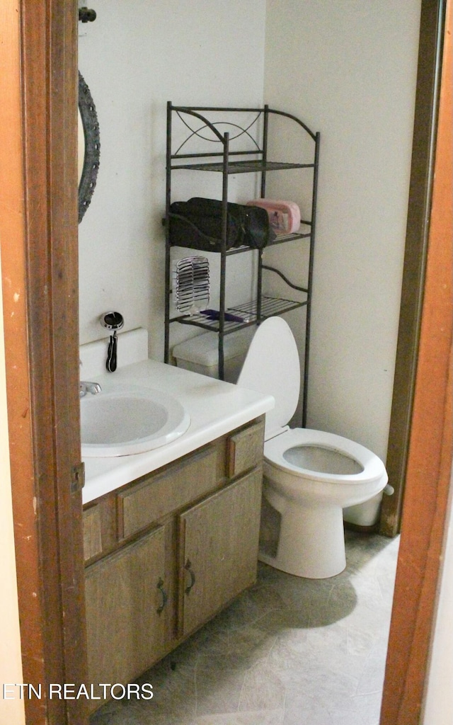 bathroom with toilet and vanity