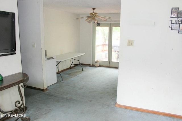 corridor with baseboards and carpet floors