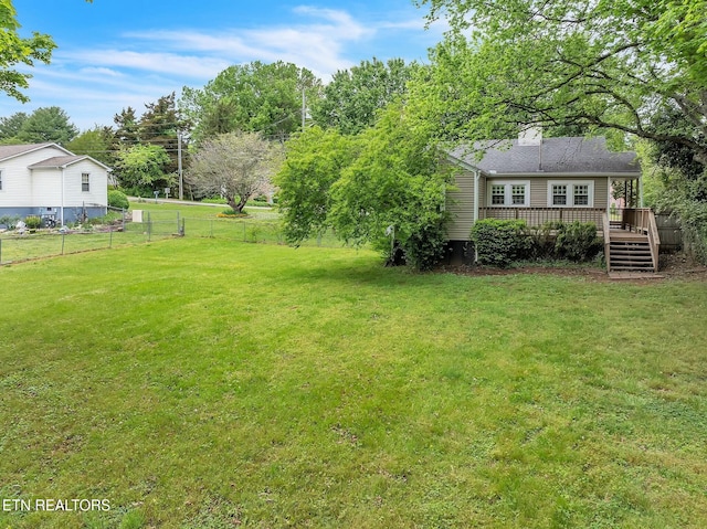 view of yard with fence and a deck