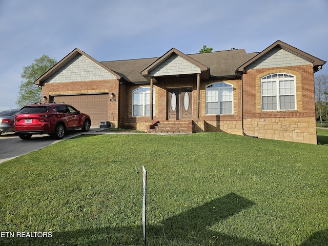 ranch-style home with an attached garage, a shingled roof, and a front yard