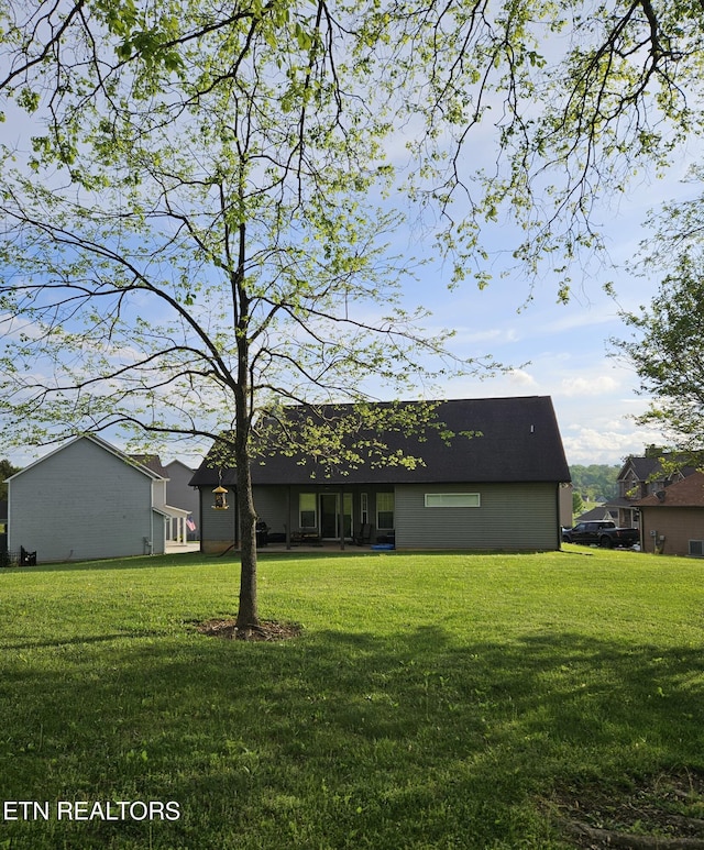 back of property with a yard