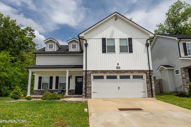 view of front of property with an attached garage, stone siding, board and batten siding, a front yard, and covered porch
