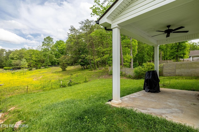 view of yard featuring ceiling fan, a patio area, and fence