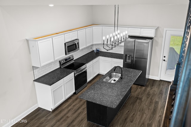 kitchen featuring backsplash, a sink, dark wood-style floors, stainless steel appliances, and white cabinetry