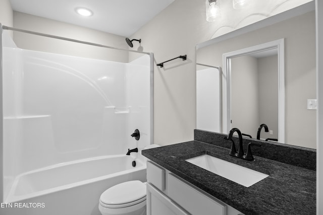 bathroom with vanity, shower / bathing tub combination, and toilet