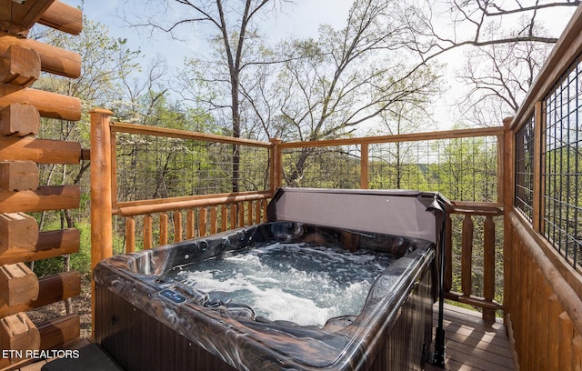 wooden terrace featuring a hot tub