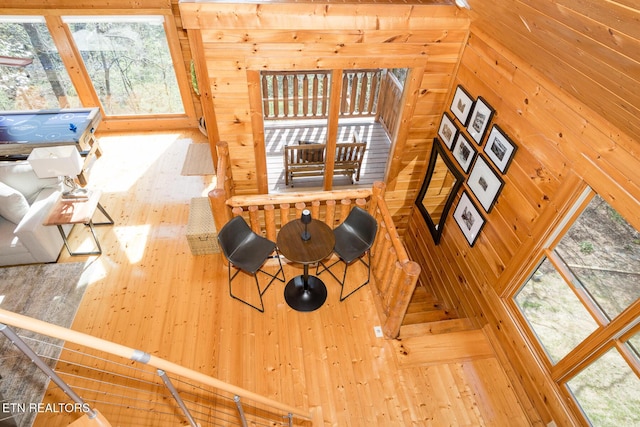 dining area featuring wood walls and hardwood / wood-style flooring