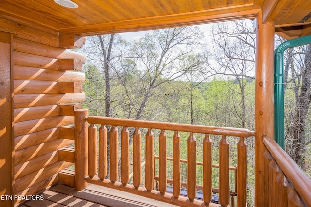 wooden terrace with a wooded view